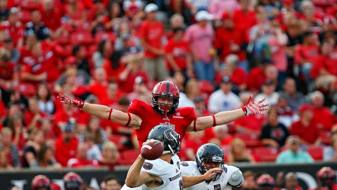 Missouri State Bears quarterback Brodie Lambert (9) tries to pass the ball in between the outstretched arms of Arkansas State Red Wolves defensive lineman Chase Robison (85) during first quarter action of the Bears' game against the Arkansas State Red Wolves at Centennial Bank Stadium in Jonesboro, Ark. on Sept. 19, 2015.
