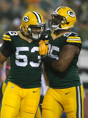 Green Bay Packers outside linebacker Nick Perry, left, celebrates his sack of Minnesota Vikings quarterback Christian Ponder with Datone Jones in the first quarter.