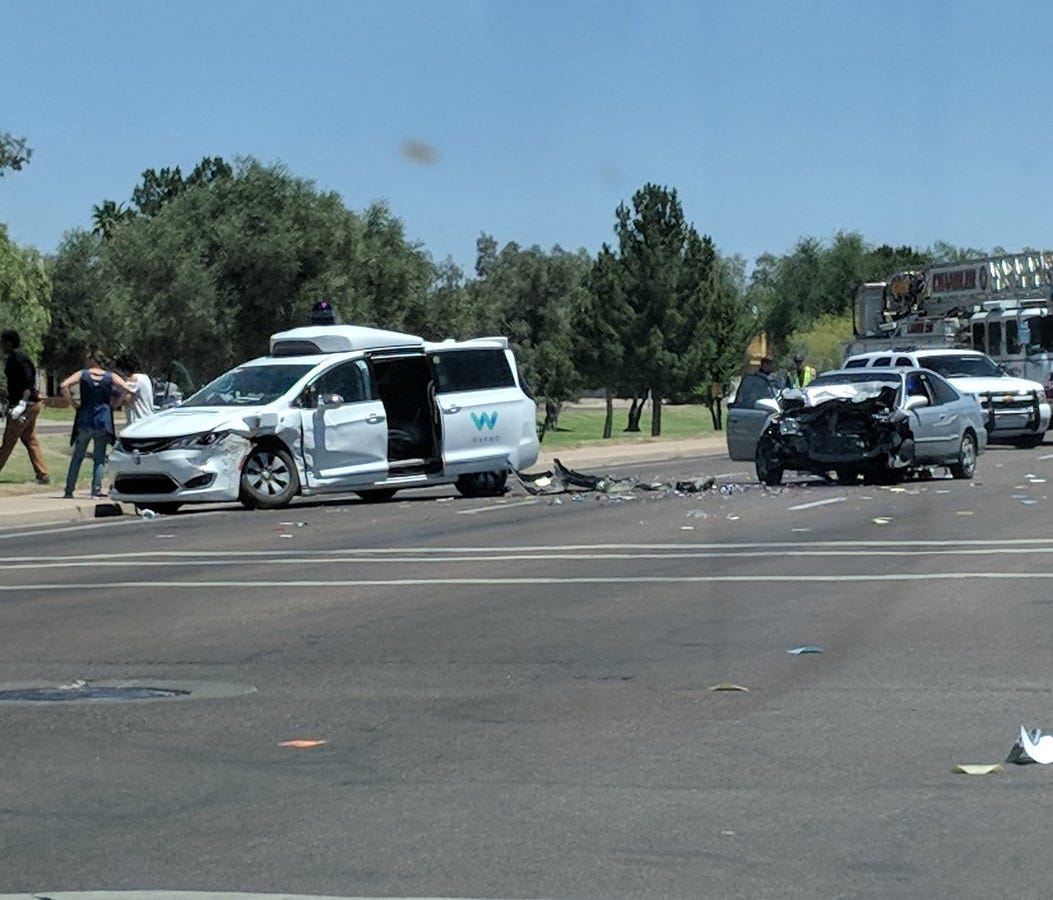 A Honda sedan swerving to avoid another car crashed into a Waymo self-driving van on May 4, 2018 in Chandler, Ariz. The can's driver was injured.