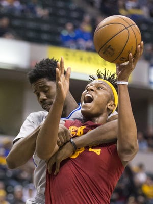 Myles Turner is wrapped up and fouled as he is defended by Brooklyn's Henry Sims, Bankers Life Fieldhouse, Indianapolis, Sunday, April 10, 2016. Indiana beat the Brooklyn Nets 129-105.