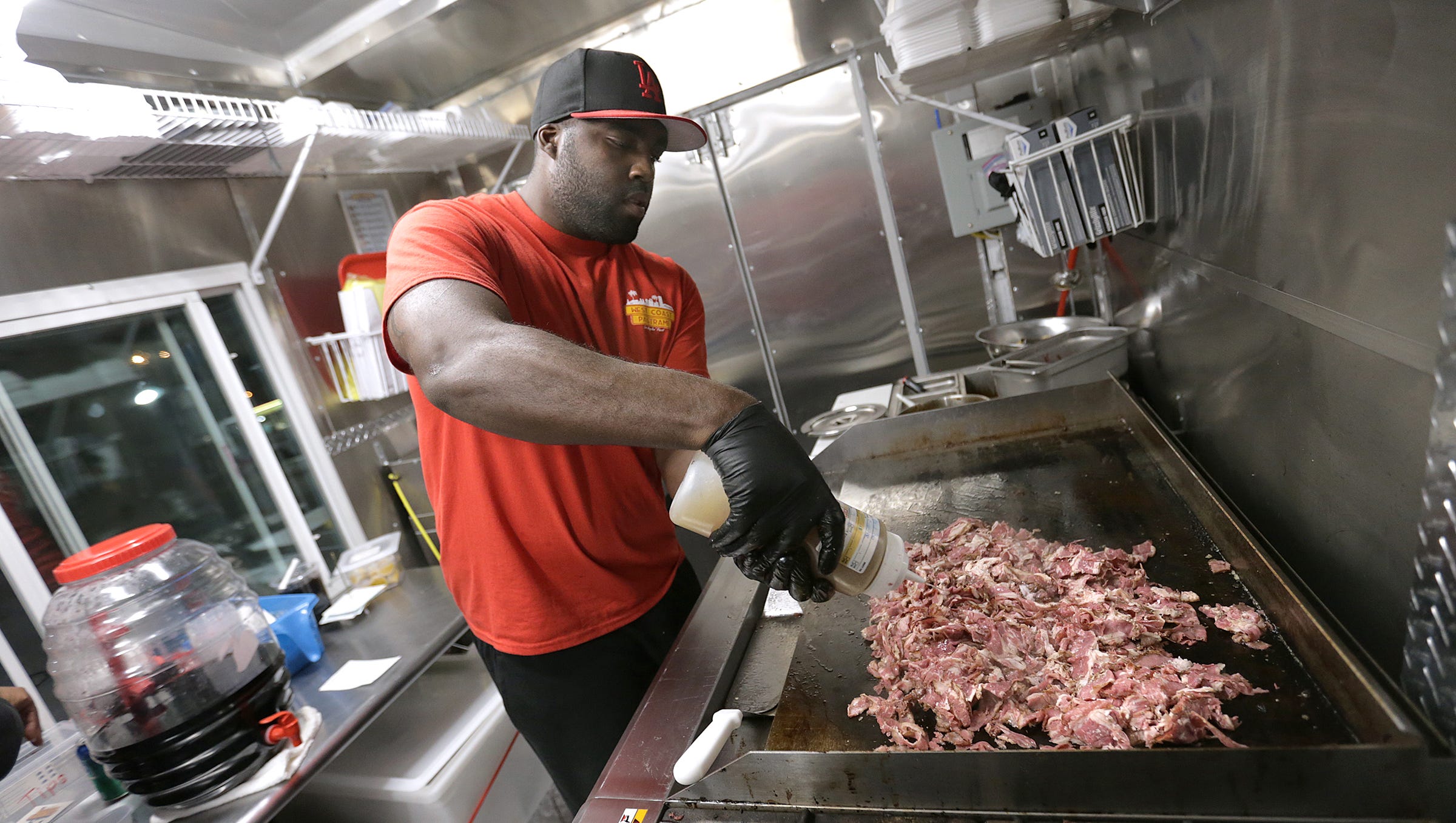 Former UTEP linebacker Darnell Murray soaks a mound of pastrami with au jus in his West Coast Pastrami food truck. The family-run business he opened with his parents has taken off in the few short months it has been open. The family knew the west coast-style pastrami would be a hit in El Paso.