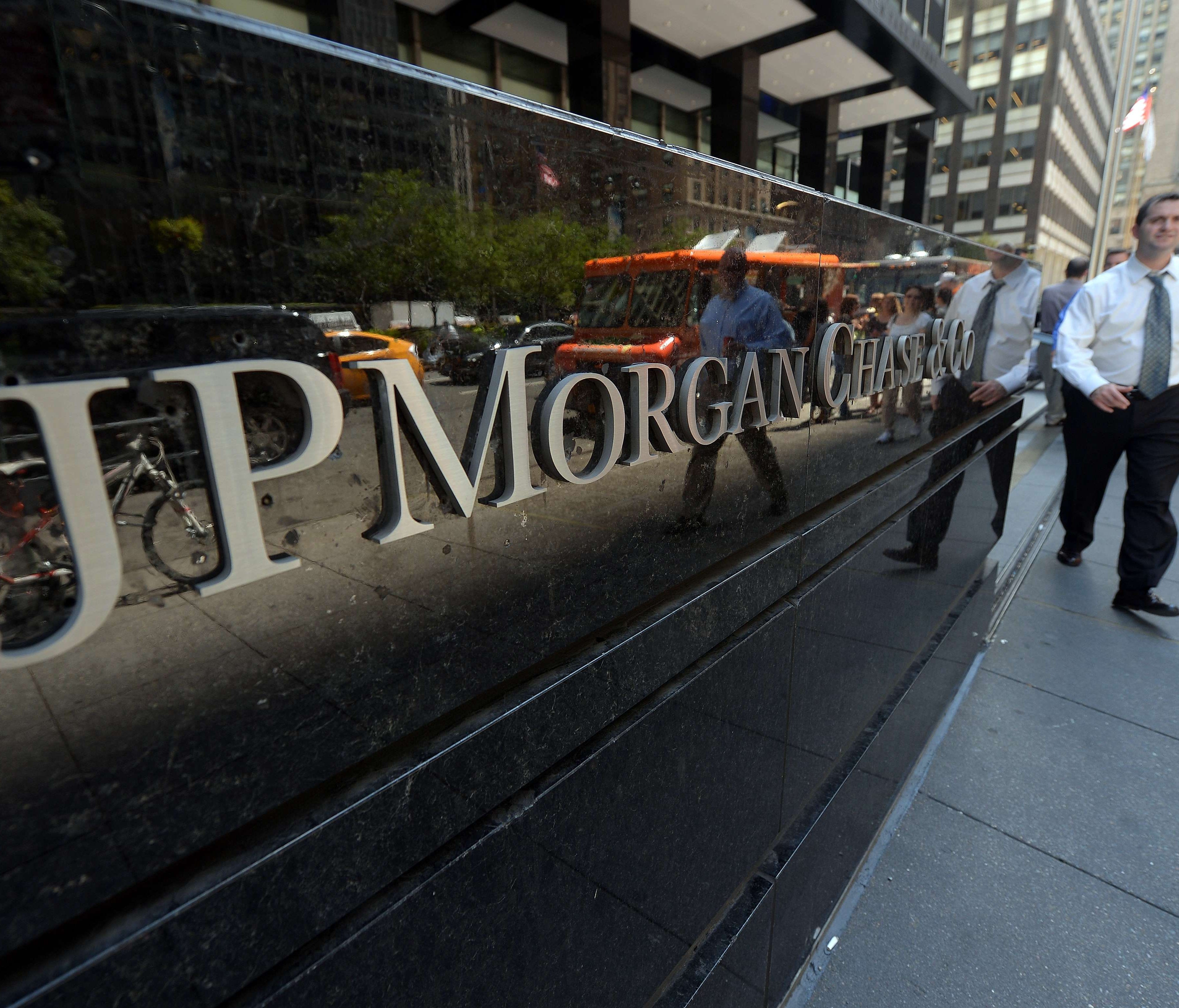 (FILES) This file photo taken on August 14, 2013 shows people walking by JP Morgan Chase & Company headquarters in New York.