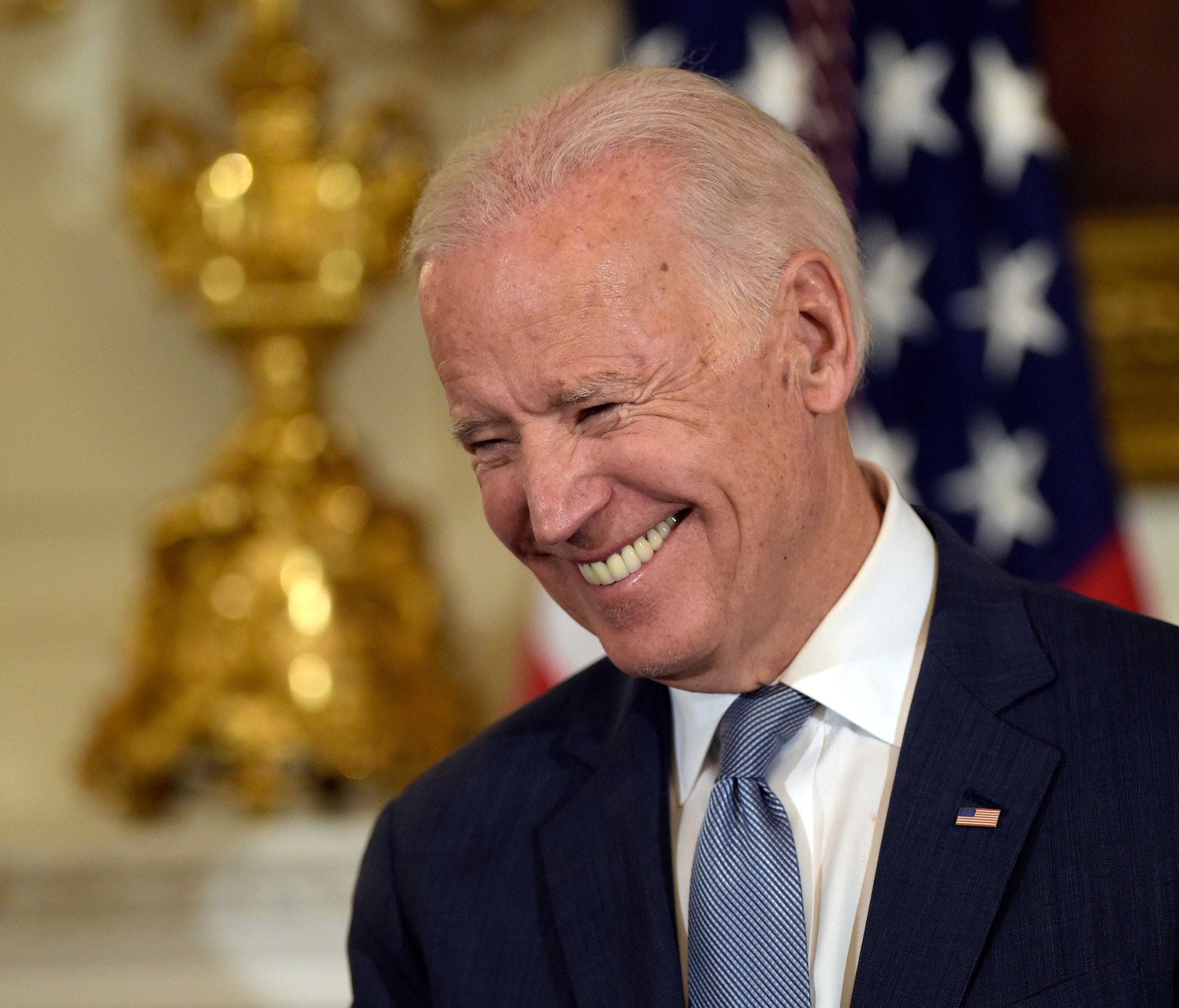Vice President Joe Biden smiles during a ceremony in the State Dining Room.