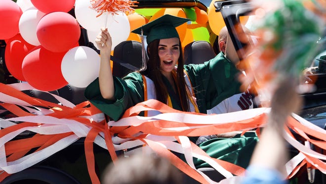 Hopkinton High graduate Tess Bouvier cheers as she passes by teachers and faculty during the Class of 2020 Celebratory Parade on May 30, 2020.