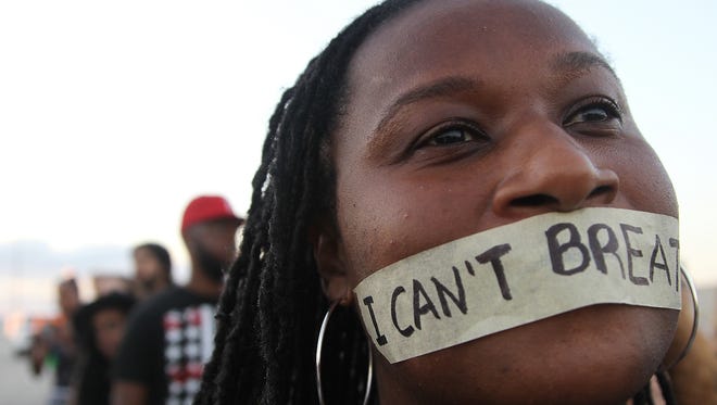 A Protestor Tapes Her Mouth With The Words I Cant Breathe
