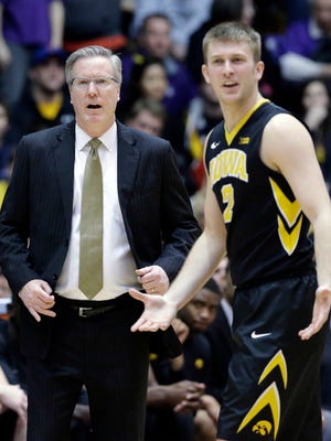 Iowa head coach Fran McCaffery, left, and guard Josh Oglesby (2) react after Oglesby was charged with a foul during overtime of an NCAA college basketball game against Northwestern, Sunday, Feb. 15, 2015, in Evanston, Ill. Northwestern won 66-61. (AP Photo/Nam Y. Huh)