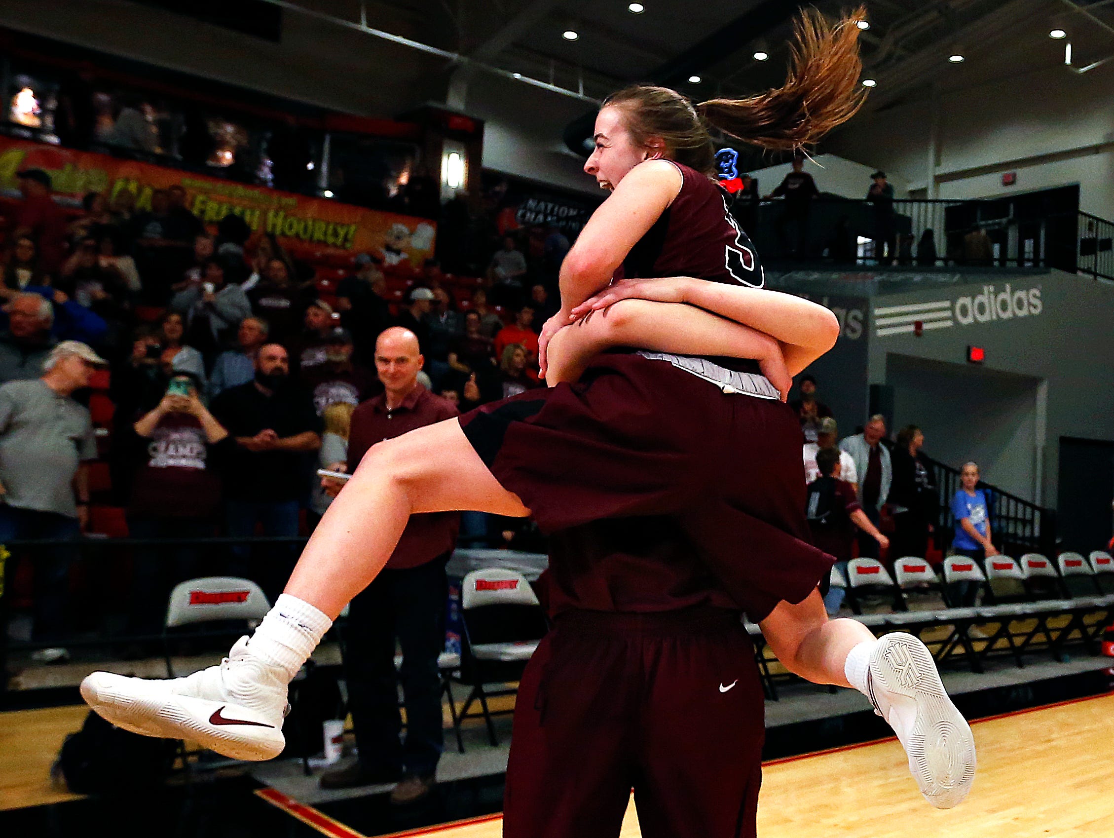 Strafford Lady Indians guard Abby Oliver (3) jumps in the arms of forward Hayley Frank (42) after the end of the MSHSAA Class 3 quarterfinal game between the Strafford High School Lady Indians and the Southern Boone High School Eagles at O'Reilly Family Event Center in Springfield, Mo. on March 4, 2017. Strafford won the game 61-34.