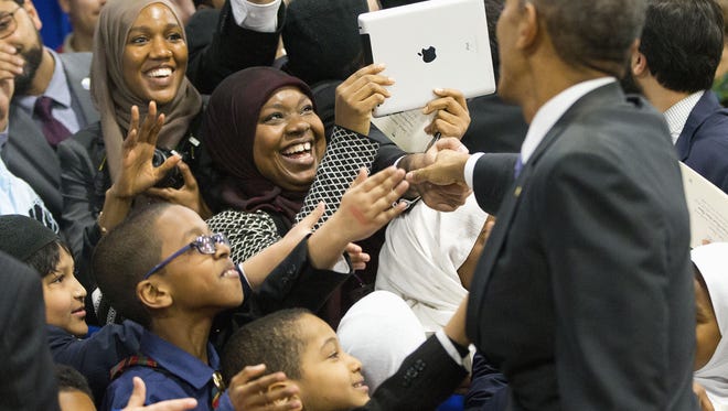 President Barack Obama greets children from Al-Rahmah school and other guests during his visit to the Islamic Society of Baltimore, Wednesday, Feb. 3, 2016, in Baltimore, Md. Obama is making his first visit to a U.S. mosque at a time Muslim-Americans say they're confronting increasing levels of bias in speech and deeds.(AP Photo/Pablo Martinez Monsivais)