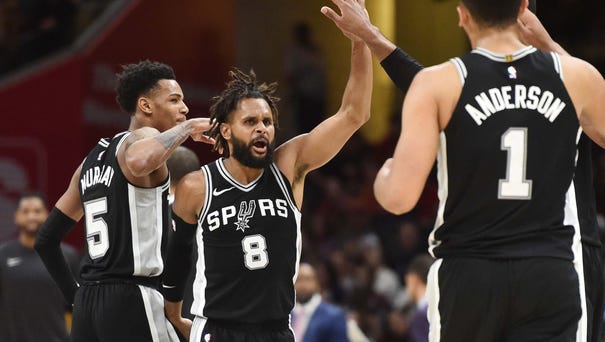 San Antonio Spurs guard Patty Mills (8) and the...