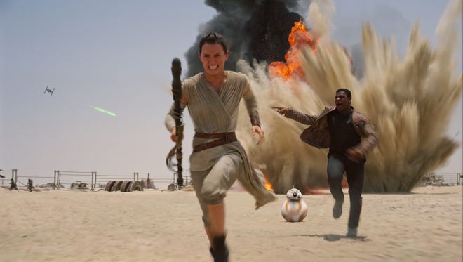 Daisey Ridley as Rey, left, and John Boyega as Finn, in a scene from "Star Wars: The Force Awakens."
