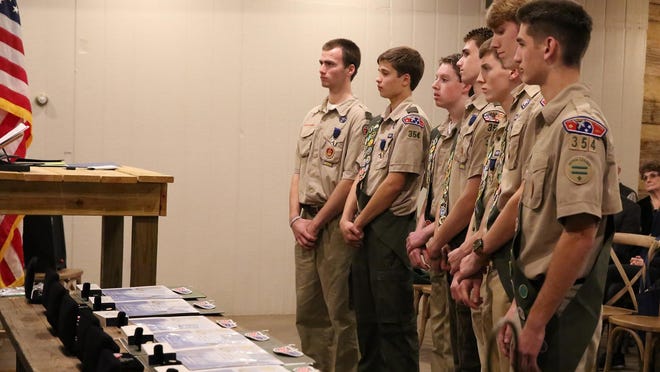 Seven of the eight Eagle Scouts from Troop 354 of Augustine School wait to receive the Eagle Charge and their awards Tuesday evening at Green Frog Farm.