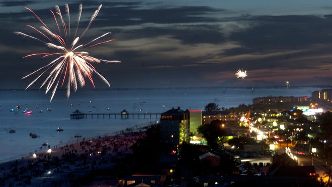 Fireworks fired by beachgoers go up at dusk on Fort Myers Beach before the official Fourth of July fireworks display.