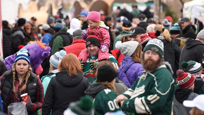 People wander through the vendors  Saturday, Jan. 20, during Hockey Day Minnesota at Lake George.