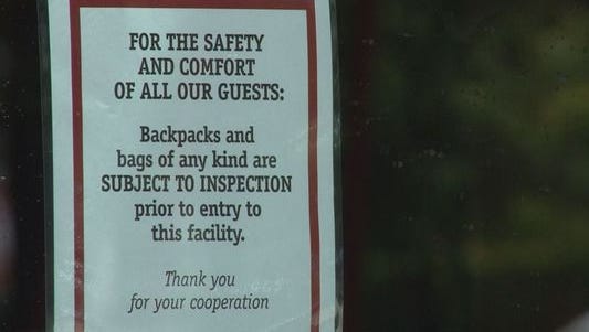 A sign posted outside a Regal theater warns patrons of the chain's bag search policy.