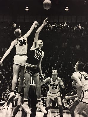 Lewisville's Marion Pierce (52) gets the tip off in