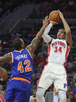 Pistons forward Tobias Harris scores against Knicks forward Lance Thomas during the second period Tuesday at the Palace.