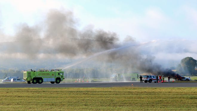 Fire departments and other agencies take part in a disaster drill Saturday at the Elmira Corning Regional Airport.
