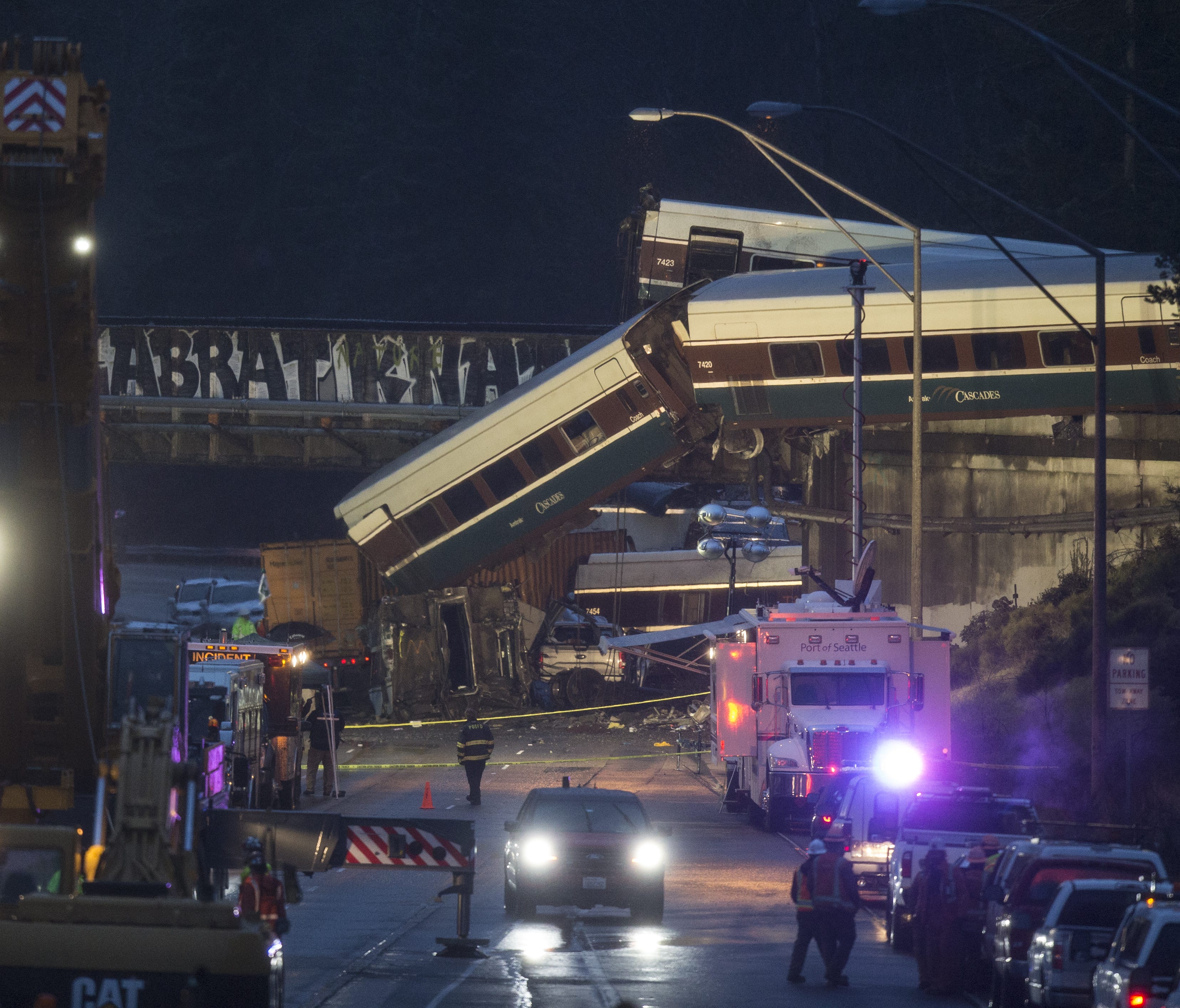Work crews prepare to clear southbound Interstate-5 lanes at the scene of an Amtrak train derailment in DuPont, Wash.