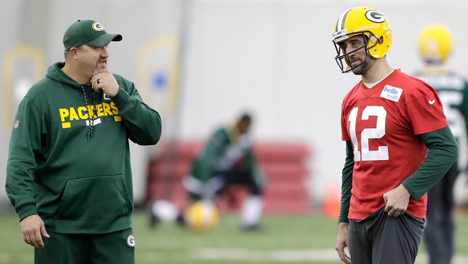 Green Bay Packers quarterback Aaron Rodgers (12) talks with quarterbacks coach Alex Van Pelt during practice at the Don Hutson Center on Dec. 13, 2017.