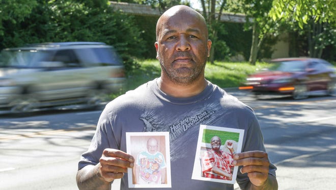 Thomas Benjamin, manager of the Bishop T. Garrott Benjamin Jr. Senior Living Center, holds photos of James Carpenter (left) and Calvin Bowie, two of the center's residents who were killed crossing North Michigan Road after being dropped off at a bus stop. The east side of the street where the men were dropped off lacks sidewalks and streetlights.