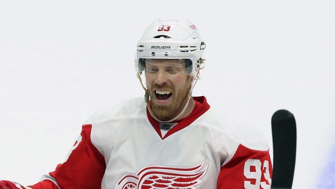 Detroit Red Wings' Johan Franzen celebrates with teammates following their 3-2 overtime win against the Ottawa Senators in an NHL hockey game in Ottawa, Ontario, Saturday, Dec. 27, 2014.