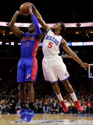 The Philadelphia 76ers' Ish Smith, right, blocks a shot by the Detroit Pistons' Reggie Jackson on March 18, 2015, in Philadelphia.