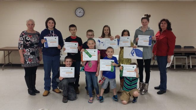 4-H Program Assistant Cheryl McCormick (left) and 4-H alumna and judge Patty Sheppard (right) congratulate participants in the Cumberland County 4-H Public Speaking Program.