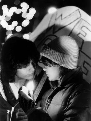 In this Dec. 4, 1980 file photo, Jay Kircher (left) and Sue Collins console each other during a memorial service at Fountain Square on the one-year anniversary of the Who concert where 11 concertgoers were killed in a crush of people.