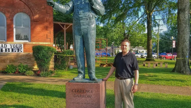 Sculptor Zenos Frudakis poses by his new statue of Clarence Darrow, who argued for evolution in the famed “Scopes monkey trial” in 1925, outside the Rhea County Courthouse in Dayton, Tenn. The 10-foot statue of Darrow who argued for evolution in the 1925 trial held at the courthouse will stand at a respectful distance on the opposite side of the courthouse from an equally huge statue of William Jennings Bryan, the Christian defender of the biblical account of creation, which was installed in 2005.