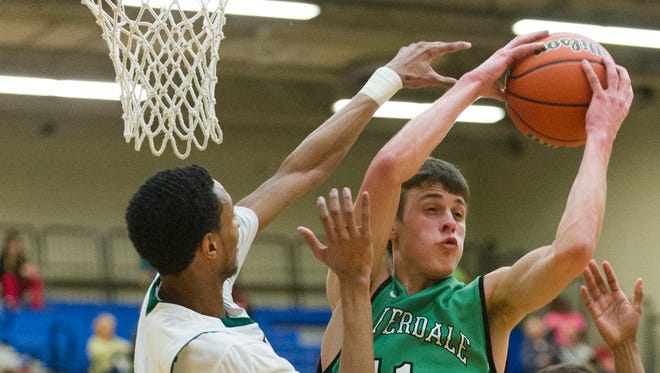 Cloverdale High School sophomore Cooper Neese (11) pulls down a rebound during the first half of action. Greenfield-Central High School hosted the IHSAA Regional Boy's 2A Basketball  tournament Saturday, March 14, 2015. 