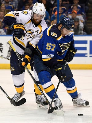 Predators left wing James Neal (18) battles for the puck with Blues left wing David Perron (57) during the first period in game 2 of the second round NHL Stanley Cup Playoffs at the Scottrade Center Friday, April 28, 2017, in St. Louis, Mo.