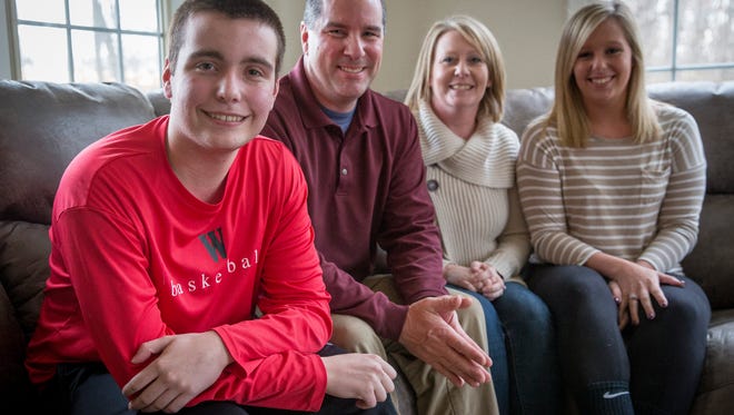 Brad Clayton, a Wapahani basketball player battling with cystic fibrosis, sits in his home with his family. Clatyon can have issues with his esophagus, trachea, pancreas, lungs and sinuses and needs to take a gauntlet of daily medications to combat the disease. 