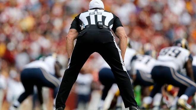 Referee Ed Hochuli watches the action during the first half of an NFL game earlier this season.