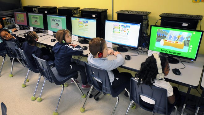 Students work on computers in Marchh 2010 during an Academy of Dover Charter School kindergarten class.