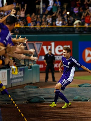 Louisville City FC's Magnus Rasmussen gets ready to leap into the crowd of fans after scoring a goal.Aug. 22, 2015