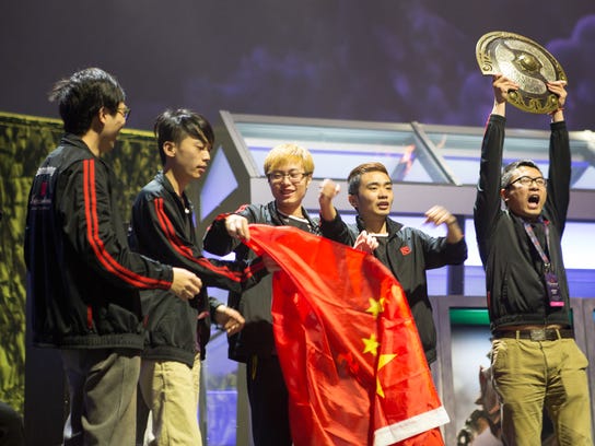 Members of Newbee esports Club hold the Aegis trophy, the top honor at The International Dota 2 Championship in Seattle in 2014.