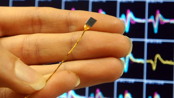 An office in Sweden is implanting tiny chips - like this one used in the brain for paralysis - into the hands of workers so they can enter the building and make purchases at the office store without exchanging money.