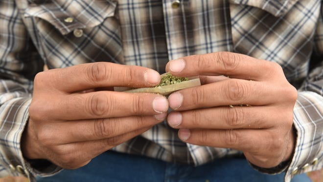 Cowboy Josh White, who has a medical marijuana card, rolls a joint in Elko, Nevada on May 19, 2017.   White is co-owner of Cannabis Consulting, a professional consulting services on all aspects of the marijuana industry.