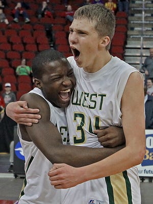 Iowa City West's #14 Devonte Lane, left, and #34 David DiLeo, right, hugged as they celebrated their win over West Des Moines Valley in Class 4-A championship final basketball game at the 2014 State Boys' Basketball Tournament at Wells Fargo Arena on Saturday night March 15, 2014.