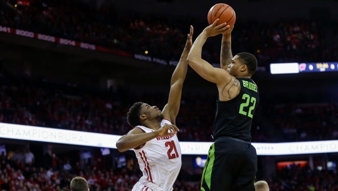 Michigan State's Miles Bridges puts up a shot over Wisconsin's Khalil Iverson during the first half.