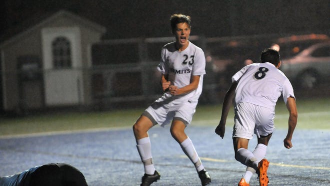 St. Augustine's Chris Theis (8) scores as Mike McAliffe (23) celebrates during Tuesday's sectional semifinal win over Paul VI.