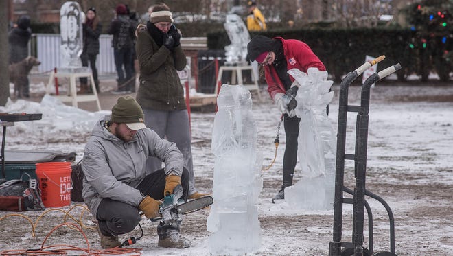 Ice carvers working Friday afternoon.