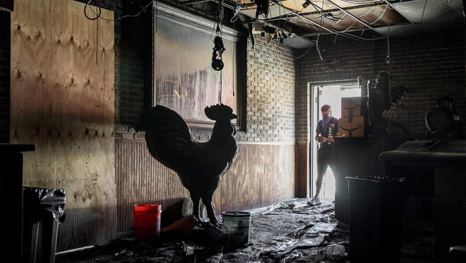 Manager Artie Vale walks through the historic H.G. Roosters after it was heavily damaged by fire on Tuesday in West Palm Beach, Florida on May 22, 2020.