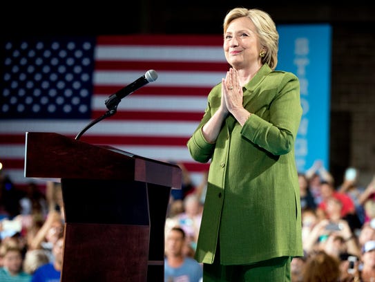 Hillary Clinton reacts to applause as she speaks at