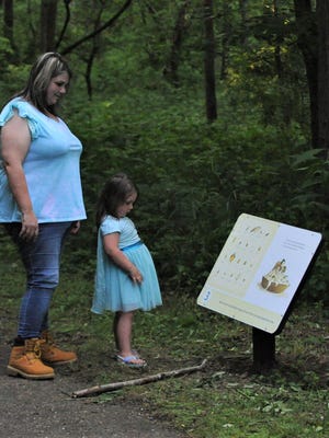 Shantae Snodgrass and her daughter, Gracelynn McConnell, read one of the panels along the Storybook Trail at Dillon State Park.