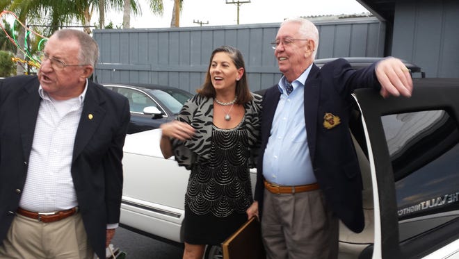 Deitrich Zimmerman, left, former owner of the Blue Heron Inn with his restaurant partner and chef Dennis Kilcoyne, right, flank current owner Alex Alexander as they arrive for the 40th-year celebration of the Blue Heron Restaurant on the Isles of Capri.
