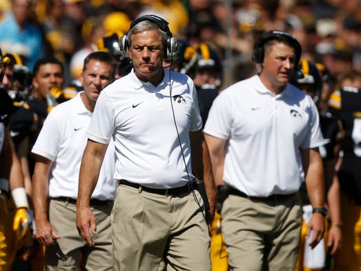 Iowa head football coach Kirk Ferentz watches from