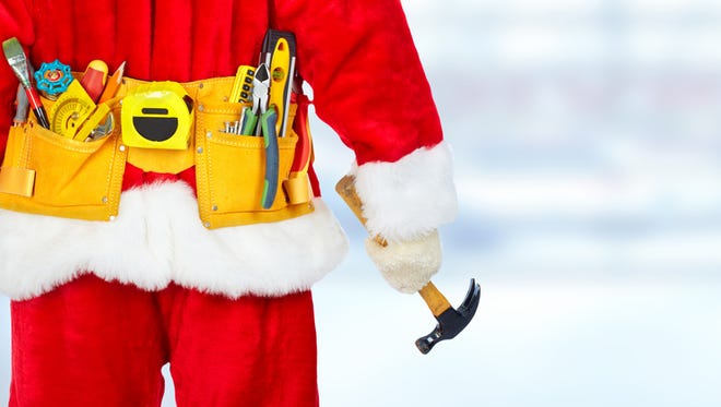 Santa construction worker with tool belt. Christmas renovation concept