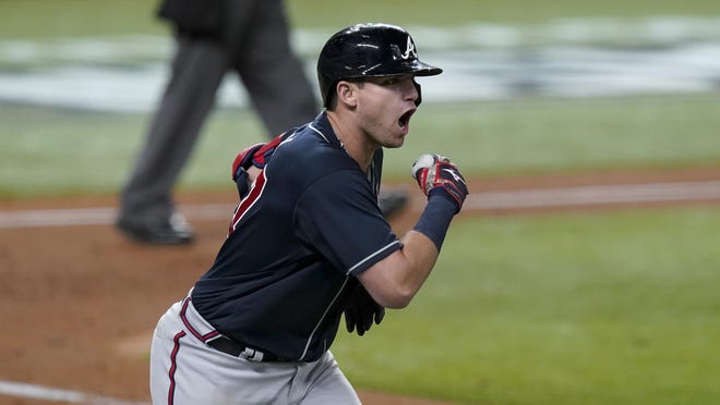 The Atlanta Braves' Austin Riley celebrates a run home against the Los Angeles Dodgers during the ninth inning in Game 1 of the National League Championship Series on Monday night in Arlington, Texas.