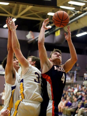 Blackman's Christian DeWitt grabs a rebound as Lawrence Co's Cade Rohling and Peyton Stockwell try for the same rebound during the Region 4-AAA final game held at Smyrna on Friday Feb. 27, 2015.